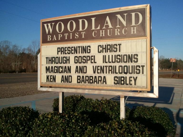 Woodland Baptist Church sign announcing Presenting Christ Through Gospel Illusions with Ken and Barbara Sibley
